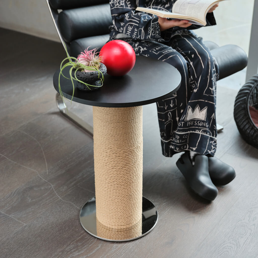 Red decorative sphere on top of the Mid-Century Modern Cat Scratching Post and Side Table, next to a modern chair.