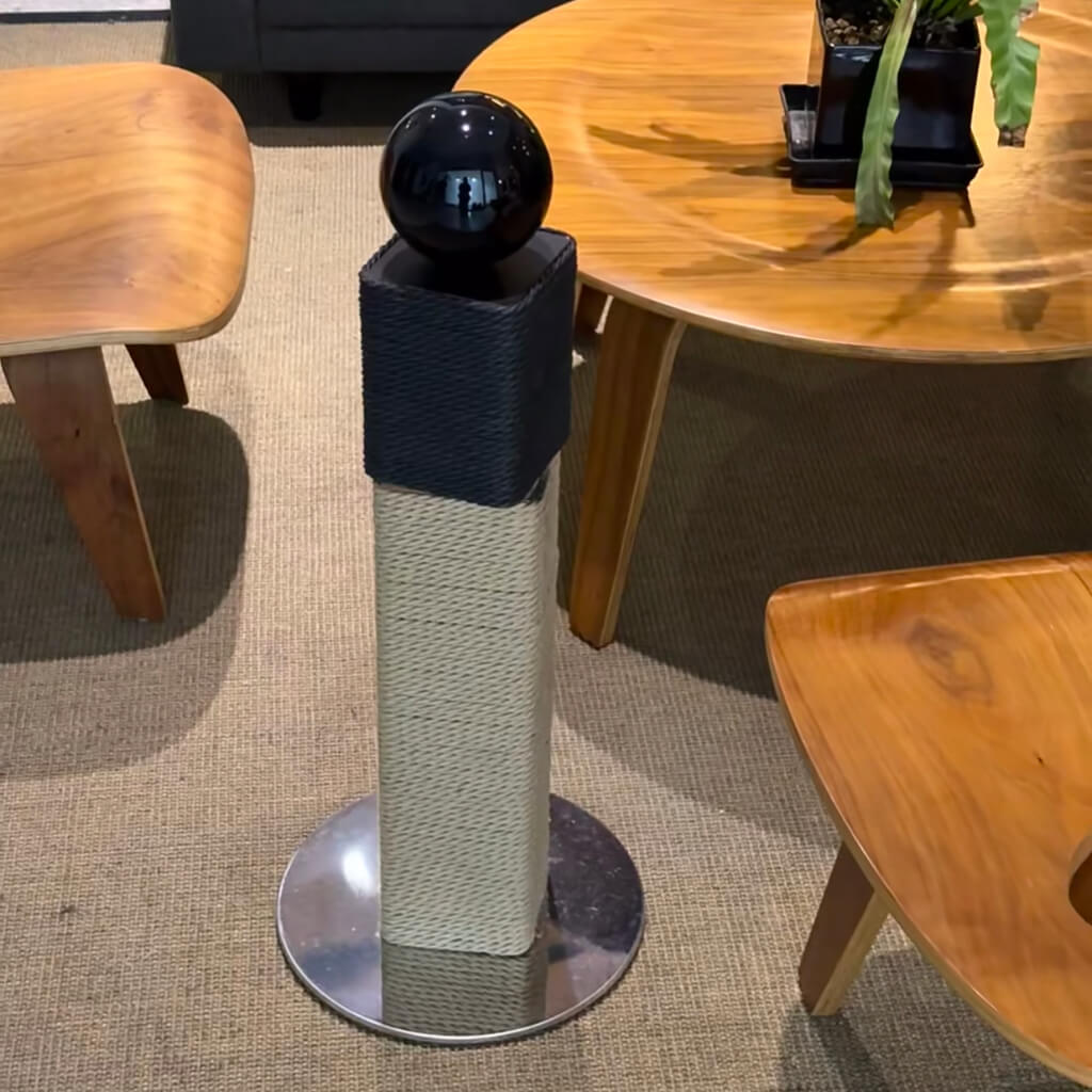 Side view of Mid-Century Modern scratching post with paper vine and stainless steel base.