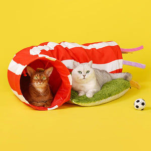 Two cats playing and resting inside the ZEZE Football Field Cat Tunnel Toy with its vibrant red and white stripes.