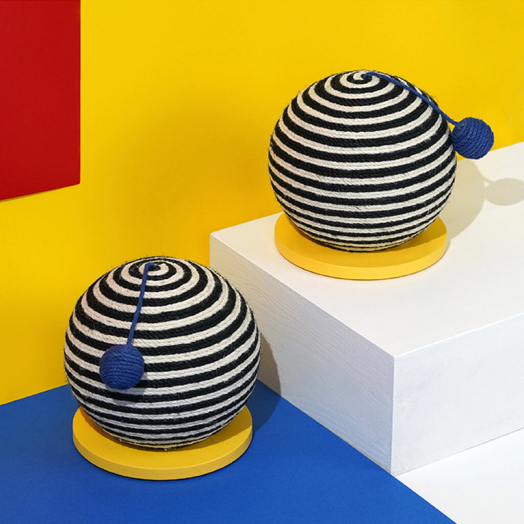 Two ZEZE Memphis Striped Sisal Cat Scratch Balls with bold black and white stripes displayed on a yellow and blue background.