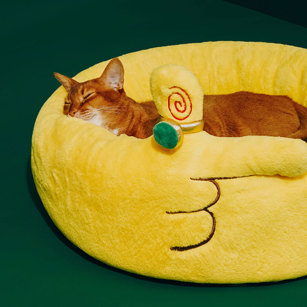 Cat sleeping peacefully in the ZEZE Meowney Plush Pet Bed with a raised side design and dollar print cushion.