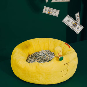 Plush hand-shaped yellow ZEZE Meowney Pet Bed on a green background, surrounded by floating dollar bills.