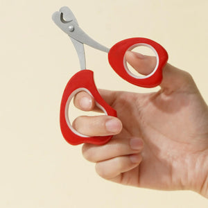 Holding ZEZE Tulip-Shaped Pet Nail Clipper, showing comfortable ergonomic grip and sharp blades.