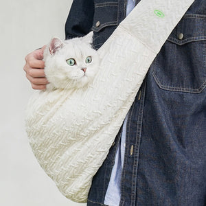 Cat peeking out of a breathable Crossbody Pet Travel Bag, ideal for secure pet transportation.