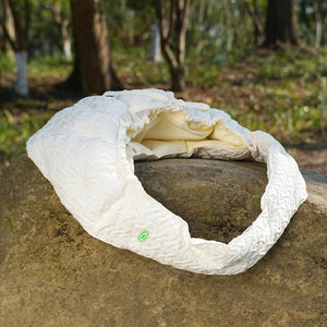 Crossbody Pet Travel Bag placed on a rock, showing its compact and easy-to-carry design.