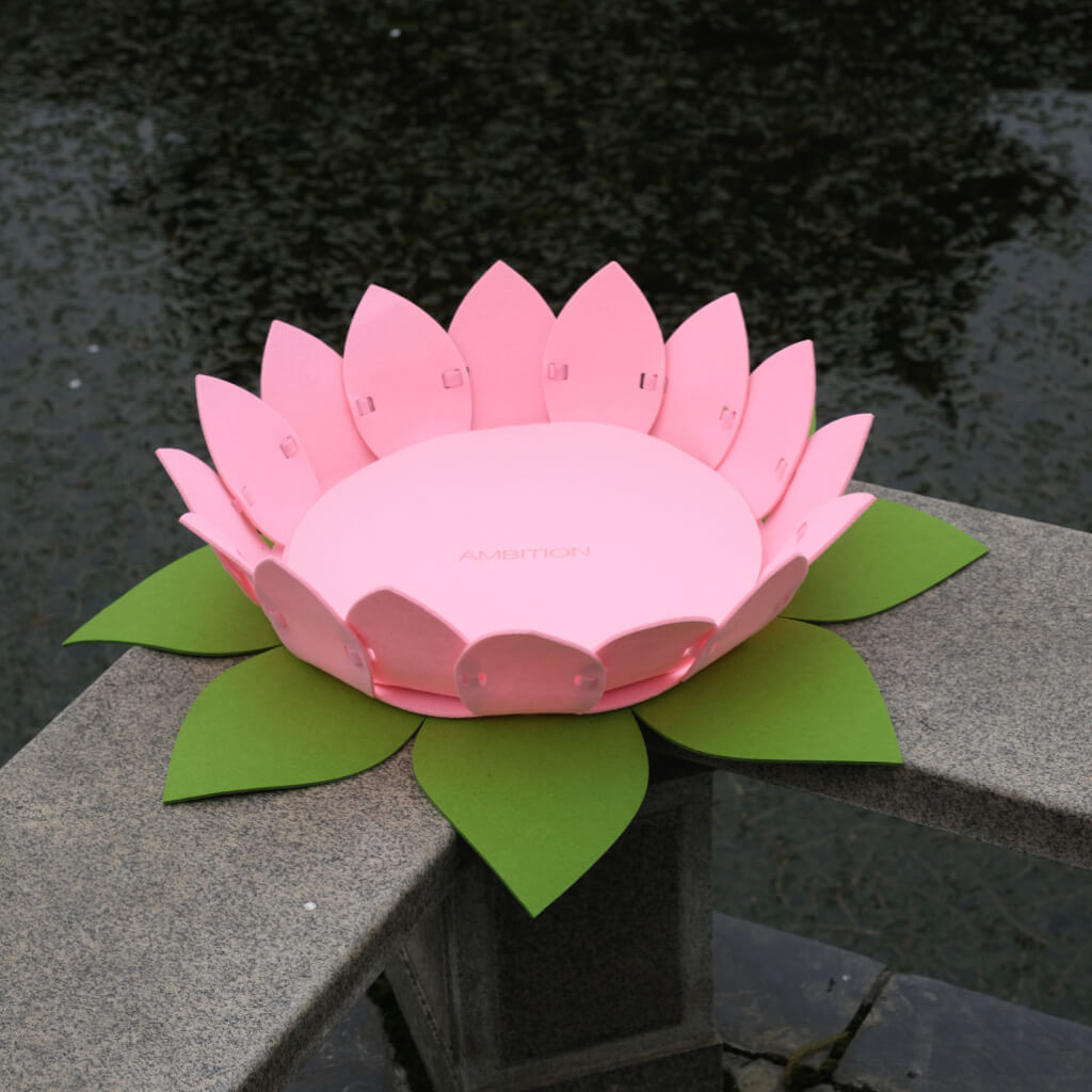 Lotus Flower Pet Bed placed near a tranquil water feature.