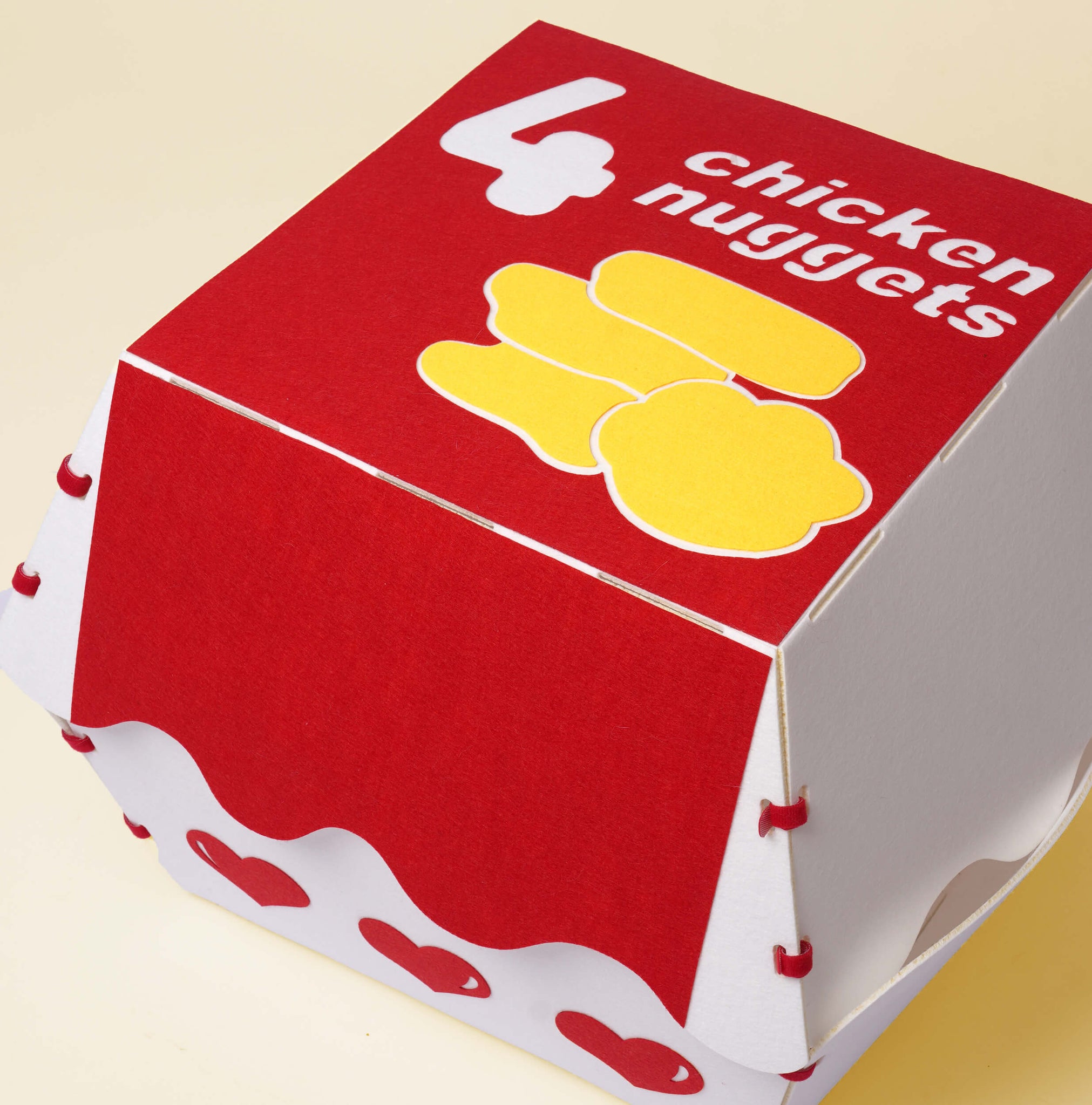 Top view of the Nugget Box Cat Hideaway, showing the nugget box theme with chicken nuggets and fun designs.