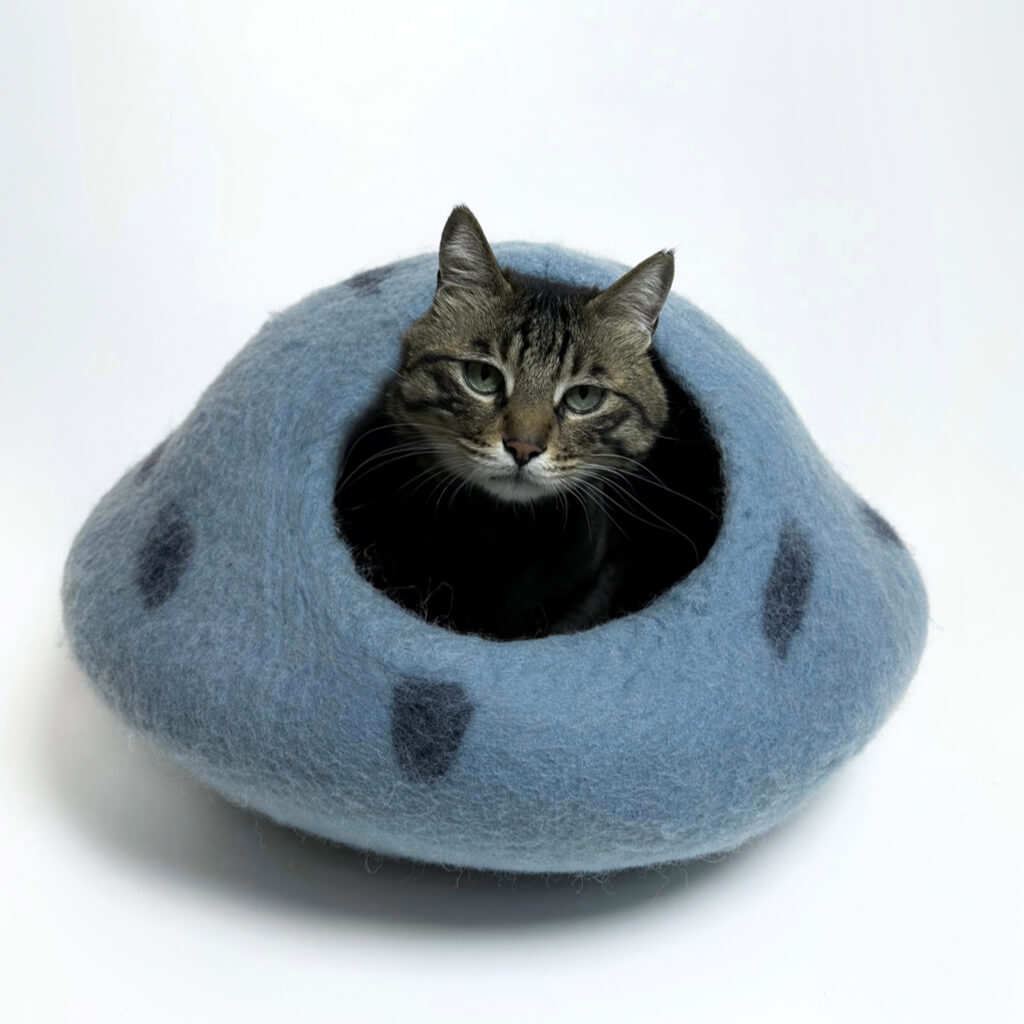 Ocean blue felt cat cave with light spots, front view showing the cozy entrance, modern hideaway for cats.