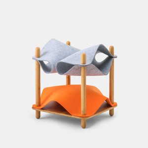 Gray and orange felt replacements arranged on a bamboo side table, creating two cozy resting spots for cats in a stylish and functional design.