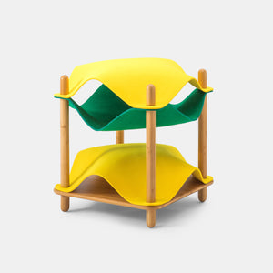 Yellow and green felt replacements stacked on a bamboo side table, offering a modern and colorful cat bed arrangement with two levels for cats to lounge.