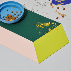 Food scattered on the vibrant Chroma Party Pet Dining Mat - #Power Green.